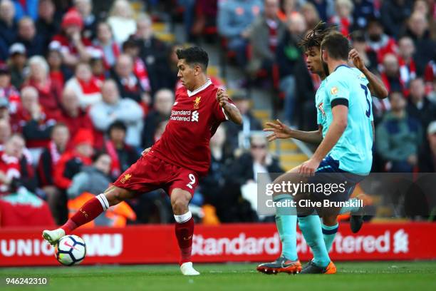 Roberto Firmino of Liverpool is challenged by the AFC Bournemouth defence during the Premier League match between Liverpool and AFC Bournemouth at...