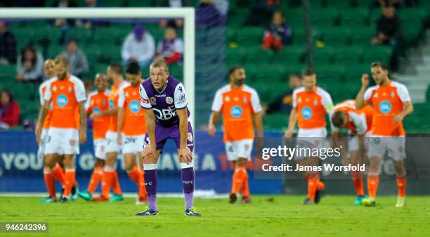 Shane Lowry of the Perth Glory looks to the big screen as watches Brisbane gets their 3rd goal during the round 27 A-League match between the Perth...