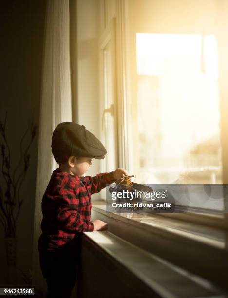 concept of dreams and travels. pilot aviator child with toy - extreem weer stock pictures, royalty-free photos & images
