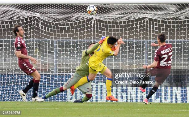 Pawel Jaroszynski of Chievo Verona competes with Salvatore Sirigu goalkeeper of Torino FC during the serie A match between AC Chievo Verona and...