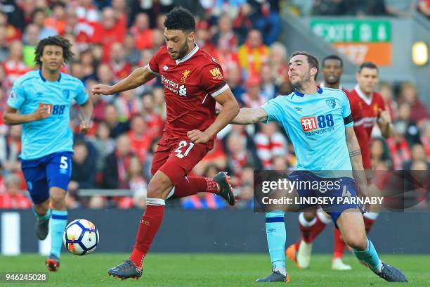 Liverpool's English midfielder Alex Oxlade-Chamberlain vies with Bournemouth's English midfielder Dan Gosling during the English Premier League...