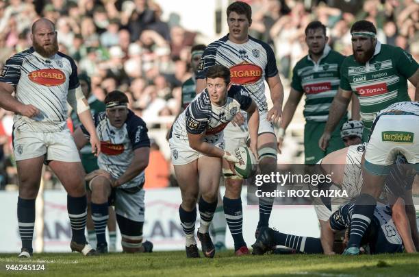 Agen's French scrum-half Hugo Verdu passes the ball during the French Top 14 rugby union match between Pau and Agen at the Hameau stadium on April 14...