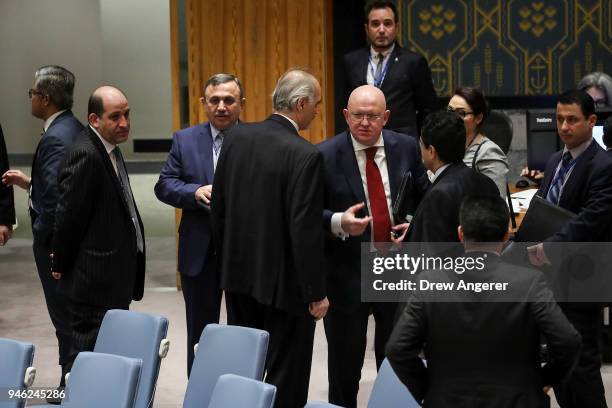 Members of the Syrian delegation delegation and Syrian ambassador to the United Nations Bashar Jaafari talk with Russian Ambassador to the United...