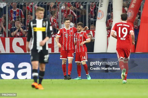 Robert Lewandowski of Bayern Muenchen celebrates with Juan Bernat of Bayern Muenchen after he scored a goal to make it 5:1 during the Bundesliga...