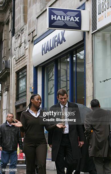 Halifax Bank employees talk as they pass by a branch of the Halifax Bank, part of the HBOS Plc. Group, in London, Tuesday, Feb. 27, 2007. Stocks in...