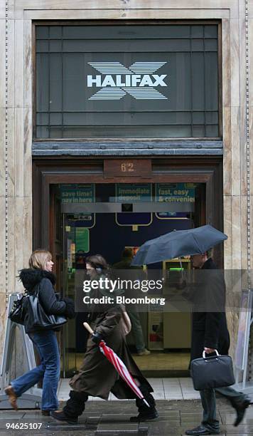 Pedestrians pass by a branch of the Halifax Bank, part of the HBOS Plc. Group, in London, Tuesday, Feb. 27, 2007. Stocks in Europe and Asia advanced,...