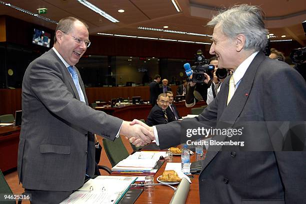 Peer Steinbrueck, the German finance minister, left, greets Jean-Claude Trichet, the President of the European Central Bank before the start of the...