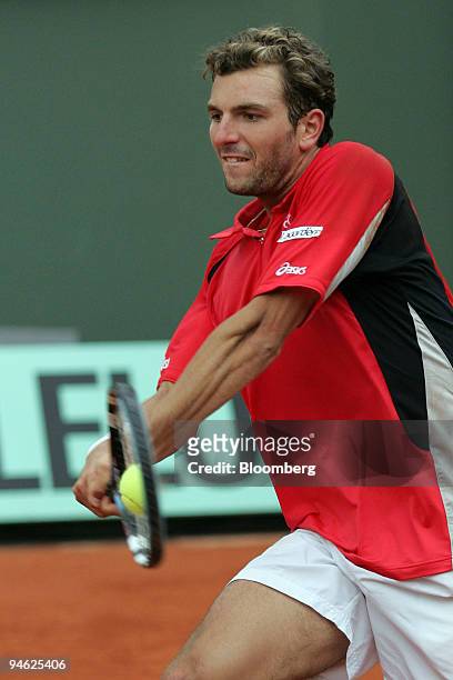 France's Julien Benneteau hits a background to Cypriot Marcos Baghdatis, during the second round of the French Open tennis tournament, at Roland...