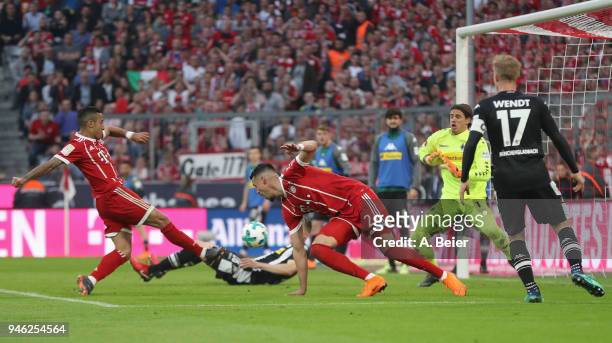 Thiago of FC Bayern Muenchen scores his first goal against goalkeeper Yann Sommer of Moenchengladbach during the Bundesliga match between FC Bayern...