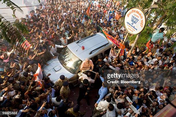 Supporters of Narendra Modi, chief minister of Gujarat State, gather as he arrives at the party's headquarters in Ahmadabad, Gujarat, India, on...