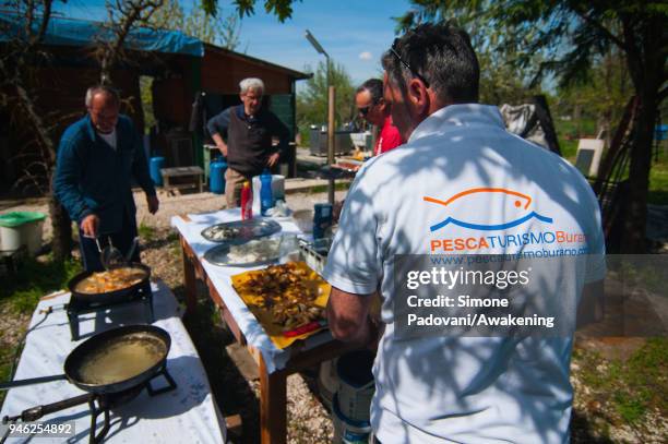 Tourists eat 'Moeche' after a fishing tour organized by Cooperativa San Marco in Burano on April 14, 2018 in Venice, Italy. At the beginning of the...
