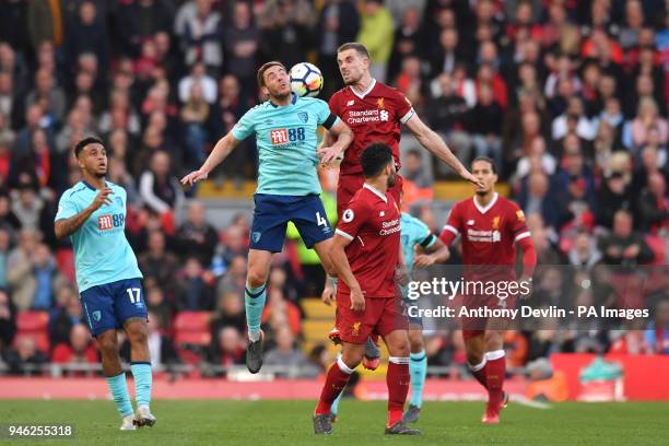 Liverpool's captain Jordan Henderson and AFC Bournemouth's Dan Gosling compete for a header during the Premier League match at Anfield, Liverpool.