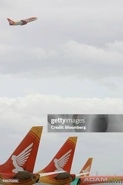 An Adam Air plane takes off while the airline's other planes are seen parked at Soekarno-Hatta International Airport in Cengkareng, Jakarta,...