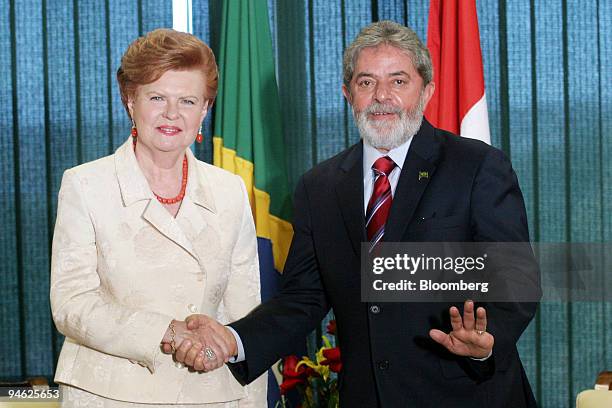 Brazilian President Luiz Inacio Lula da Silva, right, shakes hands with Vaira Vike-Freiberga, president of the Republic of Latvia, during her visit...