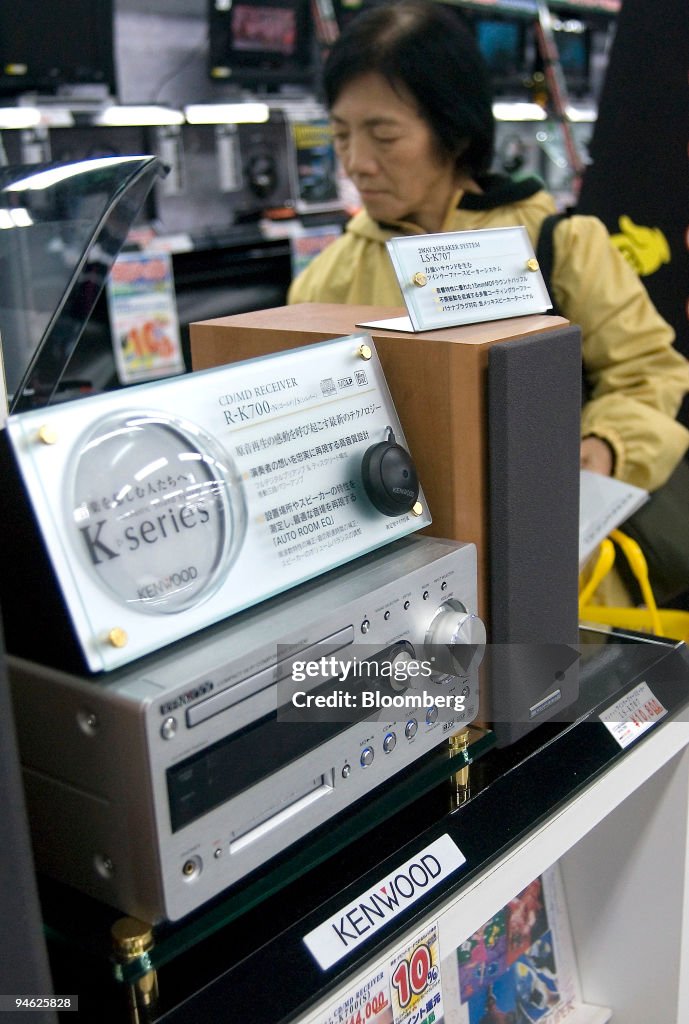 A customer looks over Kenwood Corp. stereo music systems at