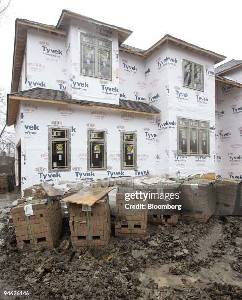 Bricks are seen piled in front of a new home under construction December 21 in Park Ridge, Illinois. The Federal Reserve Bank of Philadelphia's...