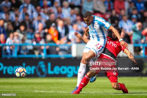 Collin Quaner of Huddersfield Town and Adrian Mariappa of Watford during the Premier League match between Huddersfield Town and Watford at John...