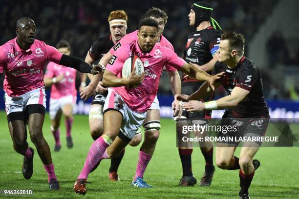 Stade Francais' French center Jimmy Yobo is challenged by Lyon's New Zealander winger Toby Arnold during the French Top 14 rugby union match between...