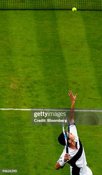 Great Britain's Tim Henman serves to Croatia's Roko Karanusic in his Davis Cup world group play-off match at the All England Club in Wimbledon,...