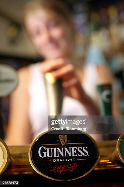Bartender pours Guinness beer at the Bell public house in Wendens Ambo, Essex, UK, Wednesday, Aug. 29, 2007. Diageo Plc, the world's biggest liquor...