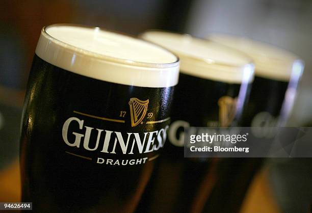 Pints of Guinness beer sit on the bar at the Bell public house in Wendens Ambo, Essex, UK, Wednesday, Aug. 29, 2007. Diageo Plc, the world's largest...