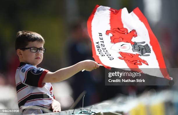 Of A young fan waves the Gloucester flag during the Aviva Premiership match between Gloucester Rugby and Harlequins at Kingsholm Stadium on April 14,...