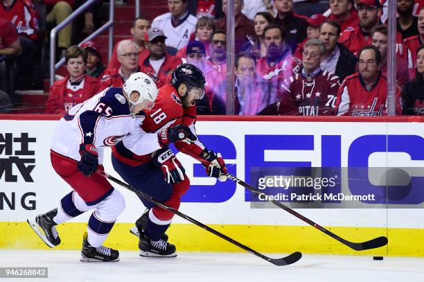 Chandler Stephenson of the Washington Capitals skates with the puck against Markus Nutivaara of the Columbus Blue Jackets in the third period in Game...