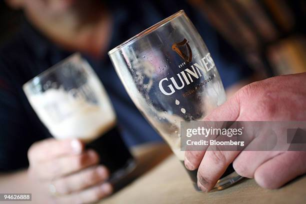 Customers drink Guinness at the Bell public house in Wendens Ambo, Essex, UK, Wednesday, Aug. 29, 2007. Diageo Plc, the world's biggest liquor maker,...