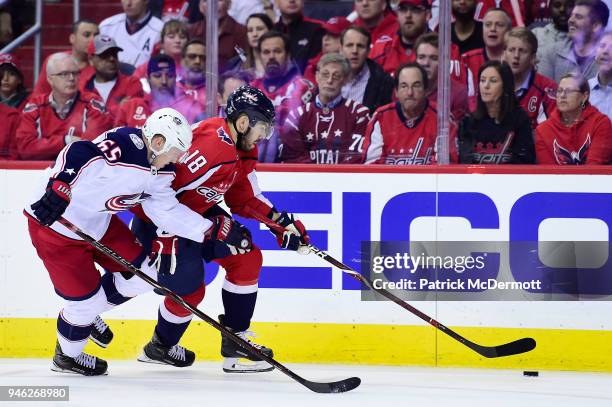 Chandler Stephenson of the Washington Capitals skates with the puck against Markus Nutivaara of the Columbus Blue Jackets in the third period in Game...
