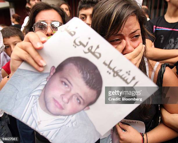 Supporters of the anti-Syrian Lebanese lawmaker Antoine Ghanem, and his two bodyguards who were killed on Wednesday by a powerful bomb, mourn during...