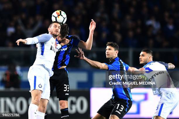 Inter Milan's Italian defender Davide Santon vies with Atalanta's Dutch defender Hans Hateboer during the Italian Serie A football match between...