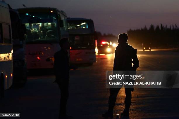 Buses carrying Jaish al-Islam fighters and their families from the former rebel bastion of Douma in Eastern Ghouta, arrive at the Abu al-Zindeen...