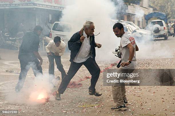 Supporters of the Hindu nationalist Bharatiya Janata Party explode firecrackers to celebrate the party's victory in Ahmadabad, Gujarat, India, on...