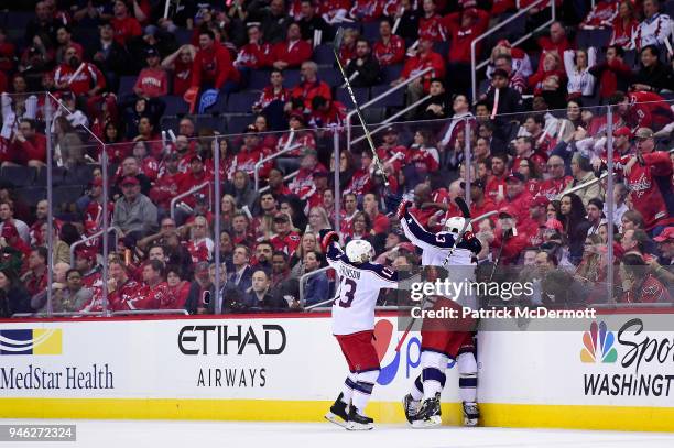 Seth Jones of the Columbus Blue Jackets celebrates with his teammates after scoring a third period goal against the Washington Capitals in Game One...