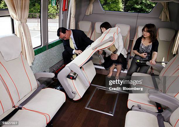 Journalists examine the interior of Mitsubishi Fuso Truck & Bus Corp.'s Aero Queen Super Hi Decker Bus in Tokyo, Japan, on Friday, June 15, 2007....