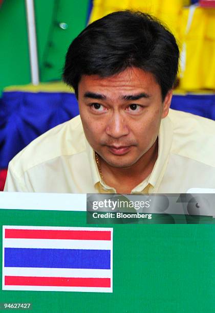 Abhisit Vejjajiva, leader of the Democrat Party, marks his ballot at a polling station in Bangkok, Thailand, on Sunday, Dec. 23, 2007. Thais from the...