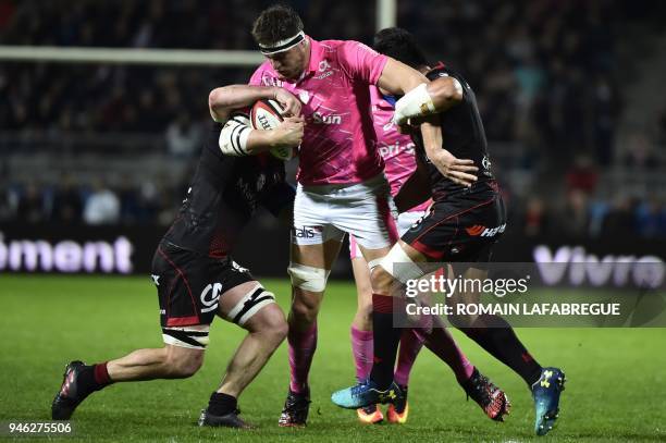 Stade Francais' French lock Alexandre Flanquart vies with Lyon's Australian flanker Liam Gill and Lyon's Australian center Rudi Wulf during the...