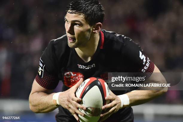 Lyon's French wing Xavier Mignot runs with the ball and scores during the French Top 14 rugby union match between Lyon and Stade Francais on April...