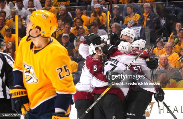Gabriel Bourque of the Colorado Avalanche is congratulated by teammates after scoring a goal against the Nashville Predators during the first period...