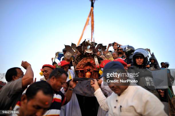 Priests carrying God Bhairab towards chariot to start pull down 'Linga' a wodden pole during the celebration of Bisket Jatra Festival at Bhaktapur,...