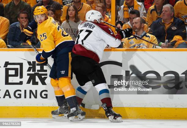 Alexei Emelin of the Nashville Predators battle along the boards against J.T. Compher of the Colorado Avalanche in Game Two of the Western Conference...