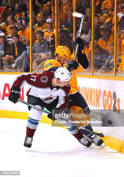 Tyson Jost of the Colorado Avalanche and Matt Irwin of the Nashville Predators fight for a puck during the first period in Game Two of the Western...