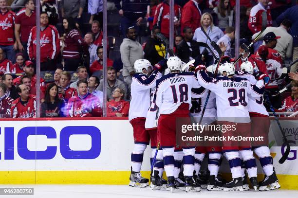 Artemi Panarin of the Columbus Blue Jackets celebrates with his teammates after scoring the game-winning goal in overtime against the Washington...