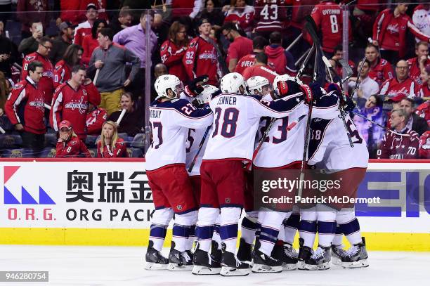 Artemi Panarin of the Columbus Blue Jackets celebrates with his teammates after scoring the game-winning goal in overtime against the Washington...