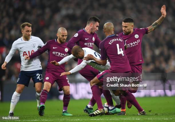 Lucas Moura of Tottenham Hotspur is fouled by Nicolas Otamendi of Manchester City, David Silva of Manchester City, Vincent Kompany of Manchester City...