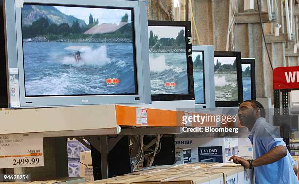 Man who declined identification looks over large screen televisions inside a Costco store, Tuesday, May 30, 2006 in Long Island City, New York.