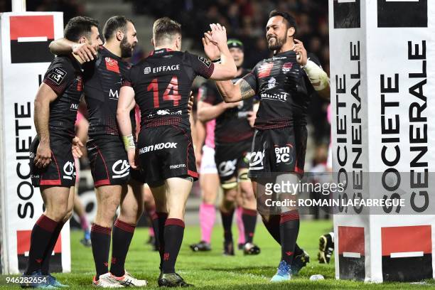 Lyon's players celebrate during the French Top 14 rugby union match between Lyon and Stade Francais on April 14, 2018 at the Matmut stadium in Lyon,...