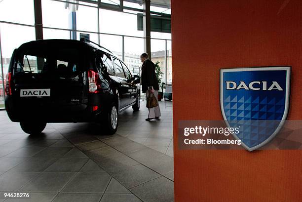 Woman looks at a Dacia Logan van at a dealership in Bucharest, Romania, on Friday, Feb. 23, 2007. With the Logan, Renault set out to design an...
