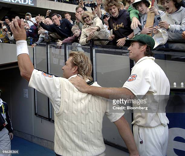 Shane Warne, left, and Glenn McGrath, of Australia, wave farewell to crowd at the Melbourne Cricket Ground, as they leave the field, after Australia...