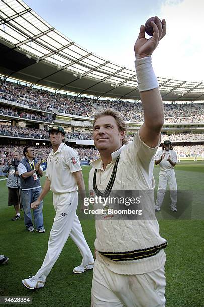 Shane Warne, of Australia, waves farewell to his home crowd at the Melbourne Cricket Ground, as he leaves the field, after Australia won the fourth...